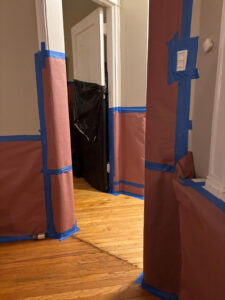 The walls were covered with garbage bags, construction paper and tape to contain the lead paint.